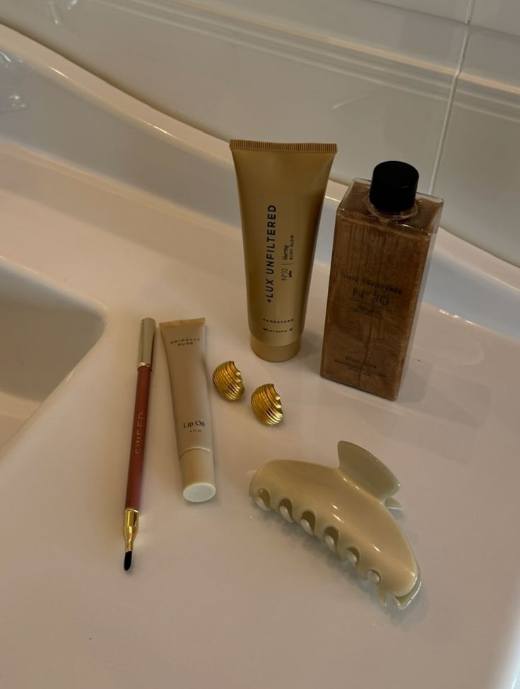 Assorted LUX Unfiltered skincare and beauty items arranged on a bathroom sink