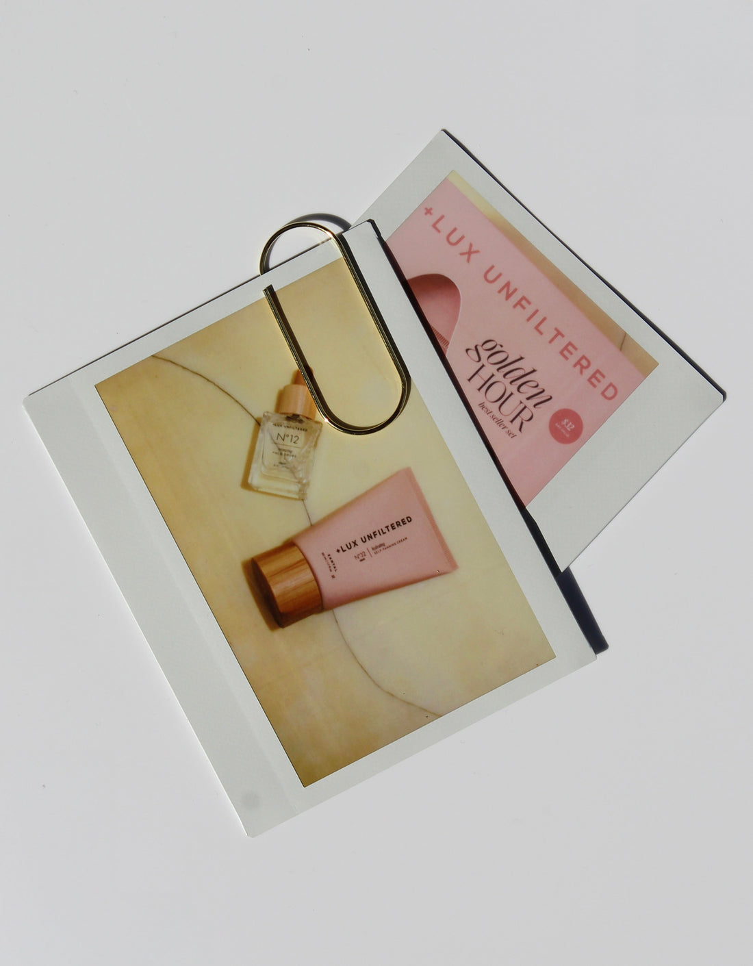 Beauty products arranged on magazines with gold sunglasses in a warm, sun-kissed setting