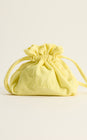 Front view of The Getaway Pouch showing pale yellow terrycloth fabric, drawstring closure, and embroidered wording on a cream background