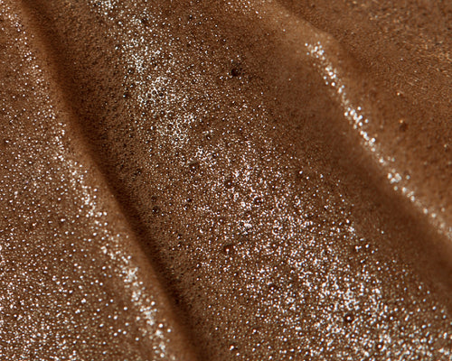Shimmery bronze makeup gel swatch with fine silver sparkles and smooth, rippled texture