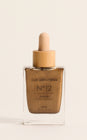 Front view of Sun Struck Tanning Face Drops in Bronze showcasing the square bottle and wooden cap with a light background