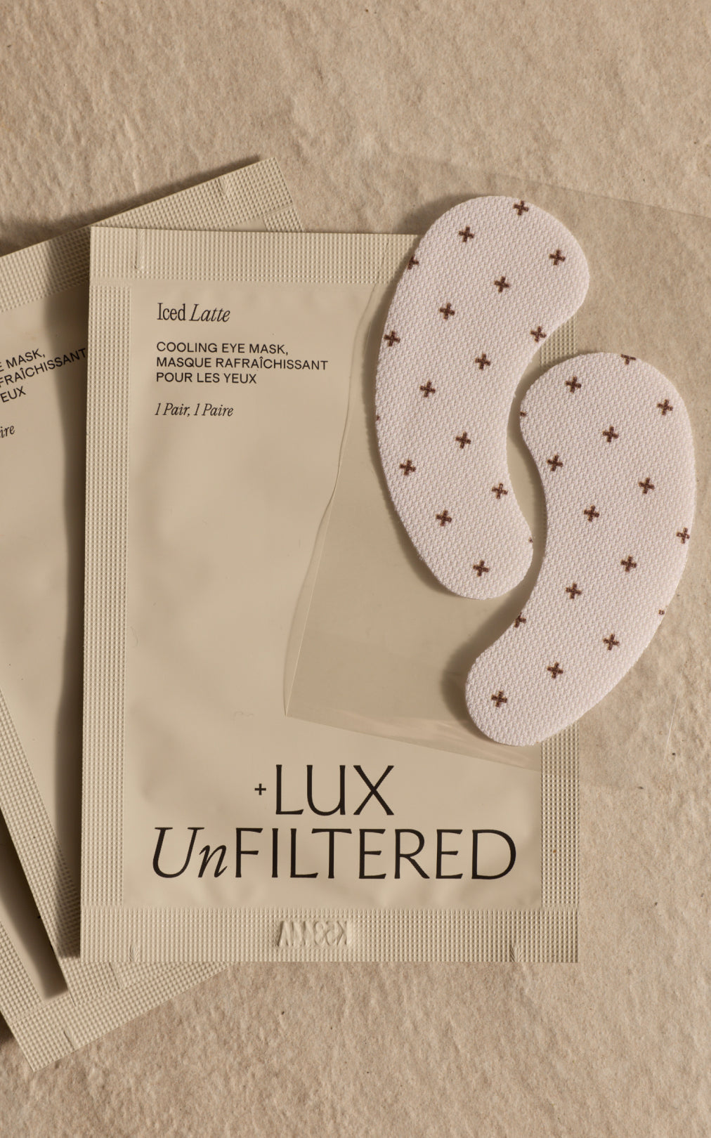 Iced Latte; COOLING EYE MASK, MASQUE RAFRAÎCHISSANT POUR LES YEUX; 1 Pair, 1 Paire; + LUX UnFILTERED; two crescent eye pads.