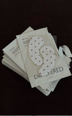 Stack of Unfiltered cooling eye mask packets (Iced Latte); visible text: Iced Latte, COOLING EYE, 1 Pair, 1 Paire