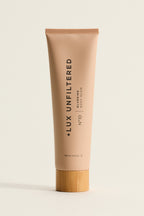 Front view of Golden Era Blurring Body Glow tube No 10 with matte beige finish and bamboo cap on light background